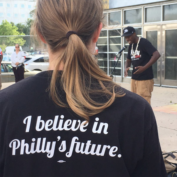 A student wearing a shirt that says, "I believe in Philly's future."